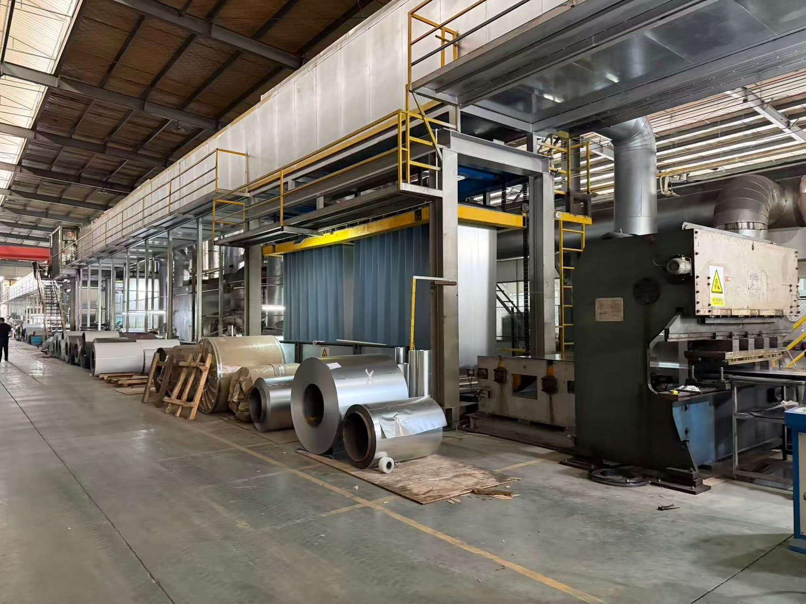 Jinghong production line with processing equipment and material rolls